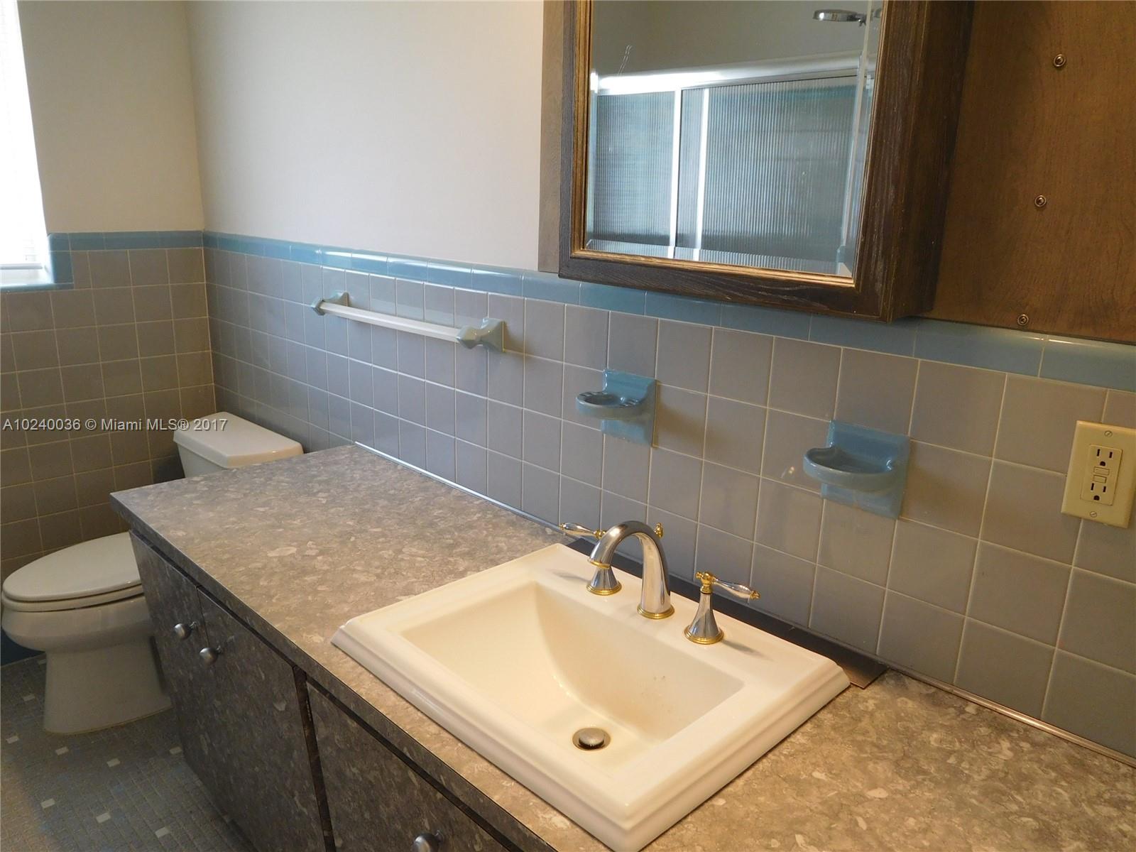 14441 Snapper Drive Coral Gables, FL 33158 - Photo 12 of 27 a bathroom with a sink and a toilet