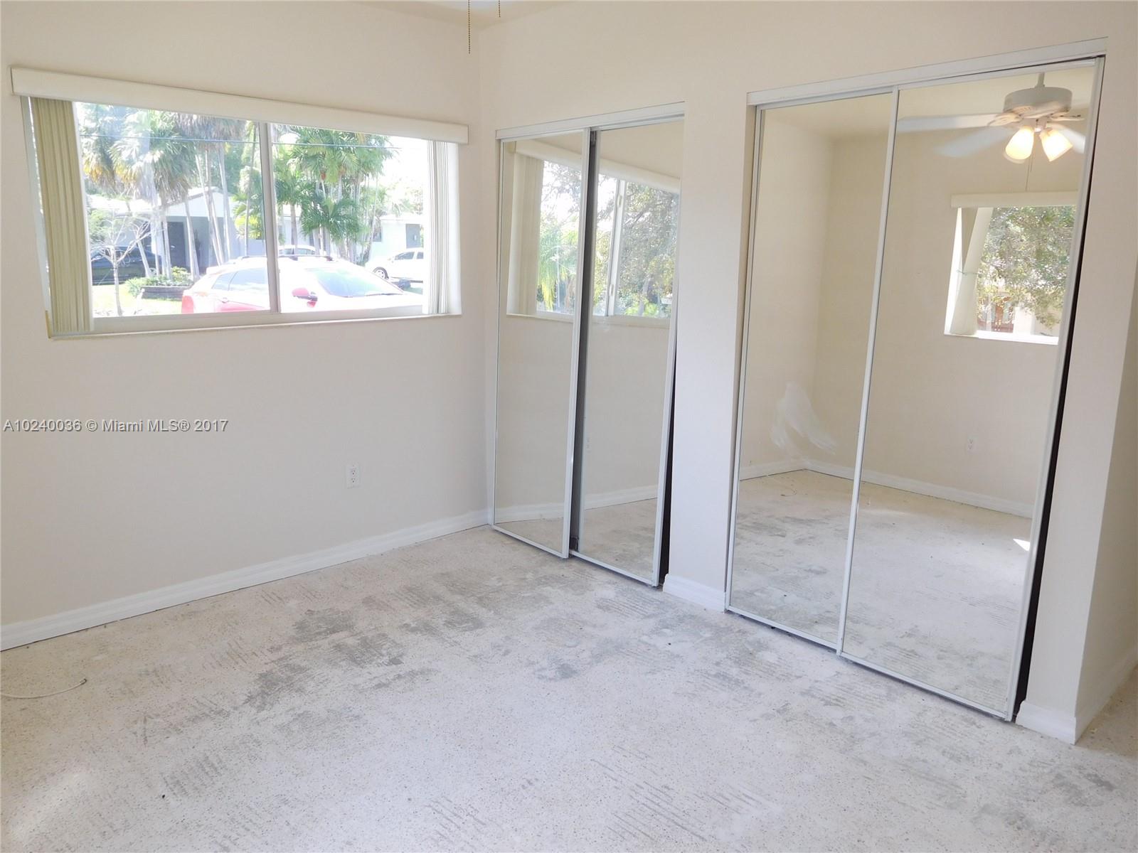 14441 Snapper Drive Coral Gables, FL 33158 - Photo 13 of 27 an empty room with windows and closet