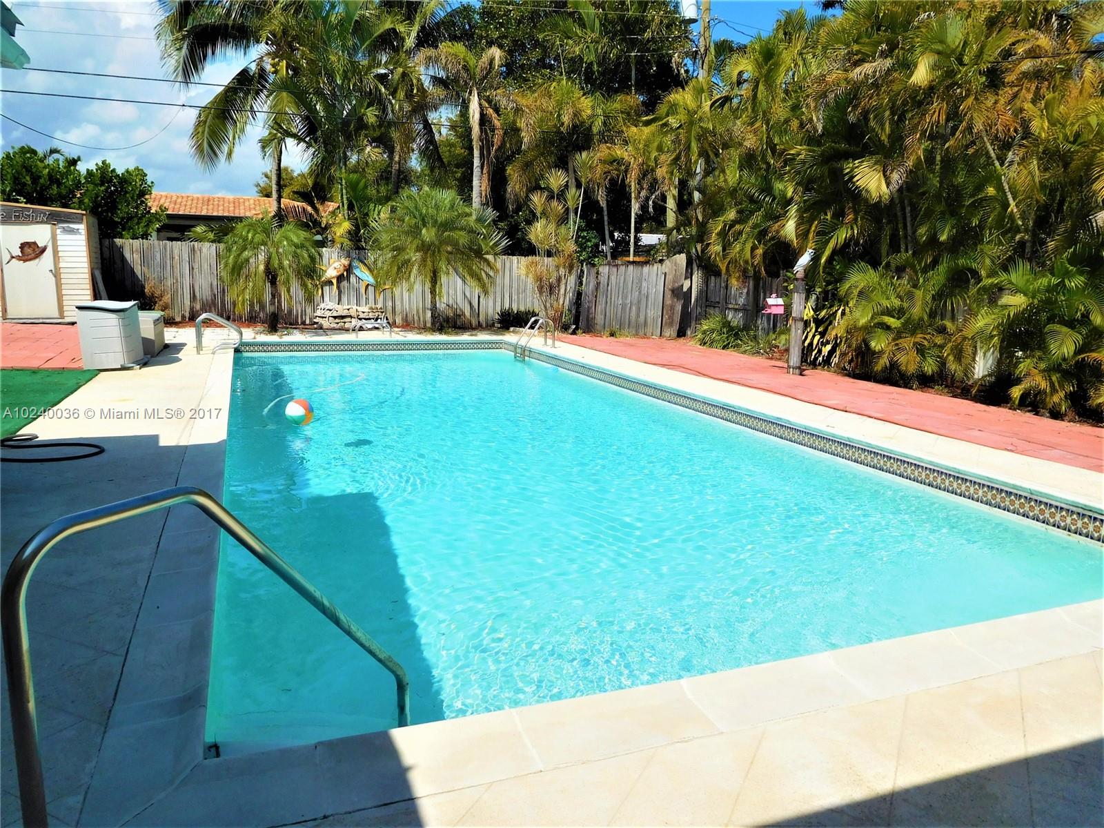 14441 Snapper Drive Coral Gables, FL 33158 - Photo 19 of 27 a view of a swimming pool with a patio