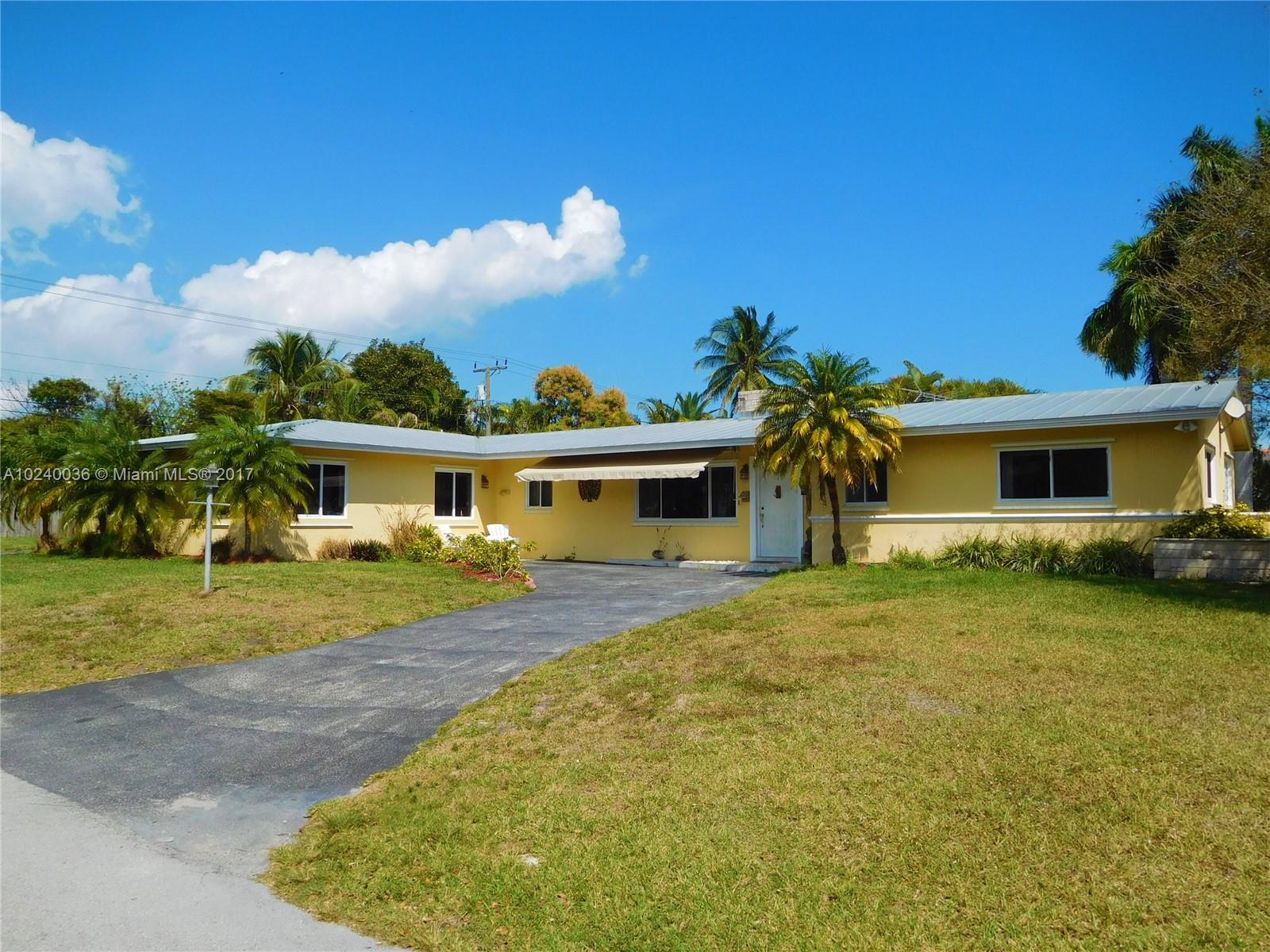 14441 Snapper Drive Coral Gables, FL 33158 - Photo 2 of 27 a front view of a house with garden