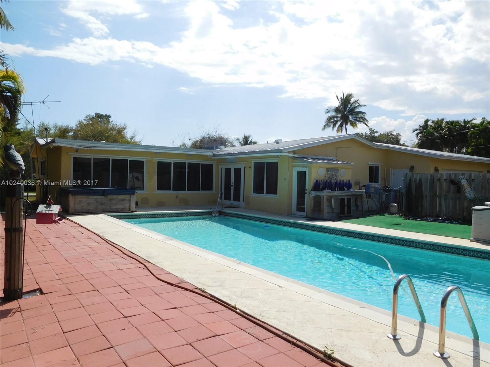 14441 Snapper Drive Coral Gables, FL 33158 - Photo 21 of 27 a front view of a house with garden