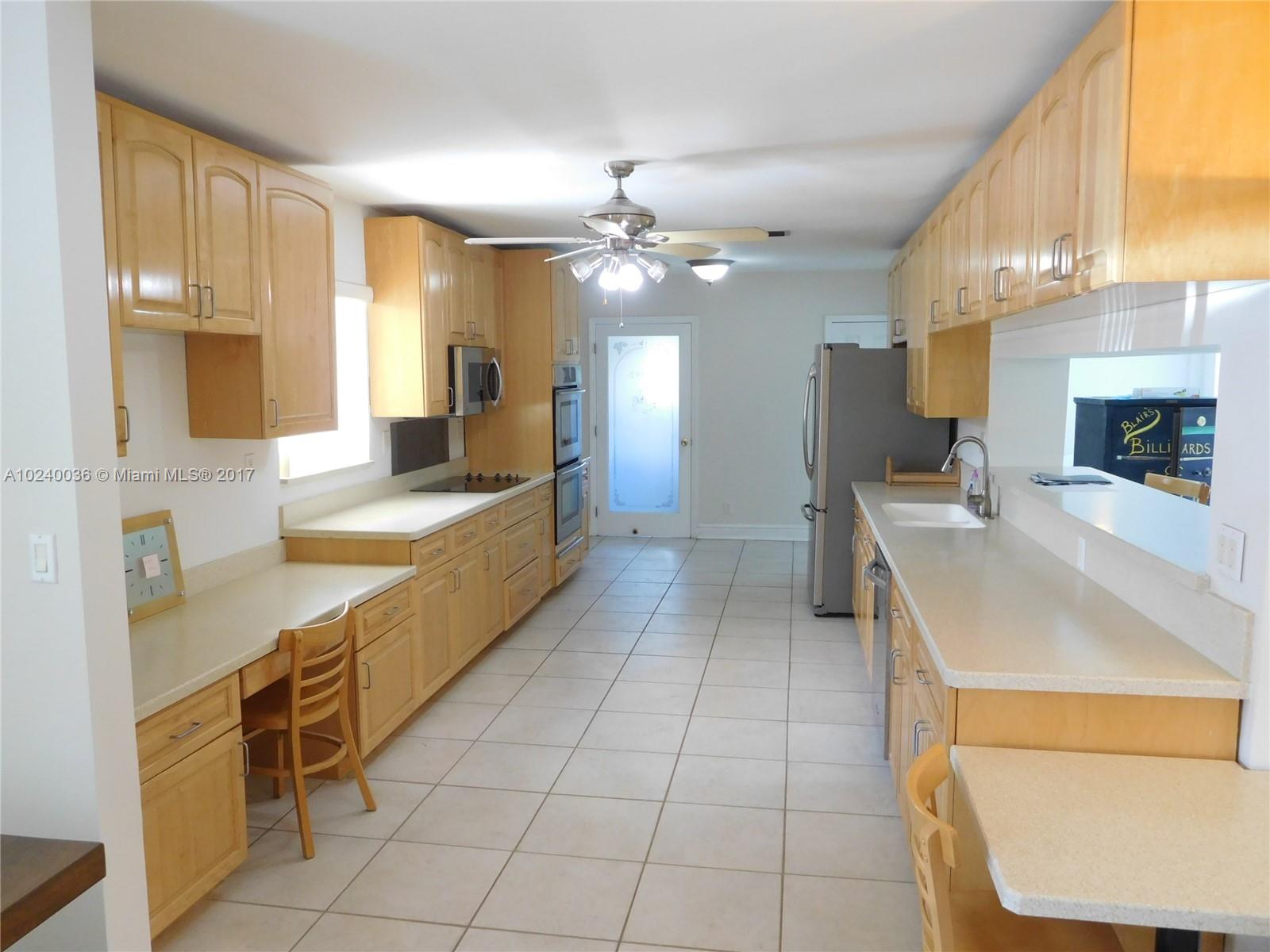 14441 Snapper Drive Coral Gables, FL 33158 - Photo 3 of 27 a large kitchen with kitchen island a sink stainless steel appliances and cabinets