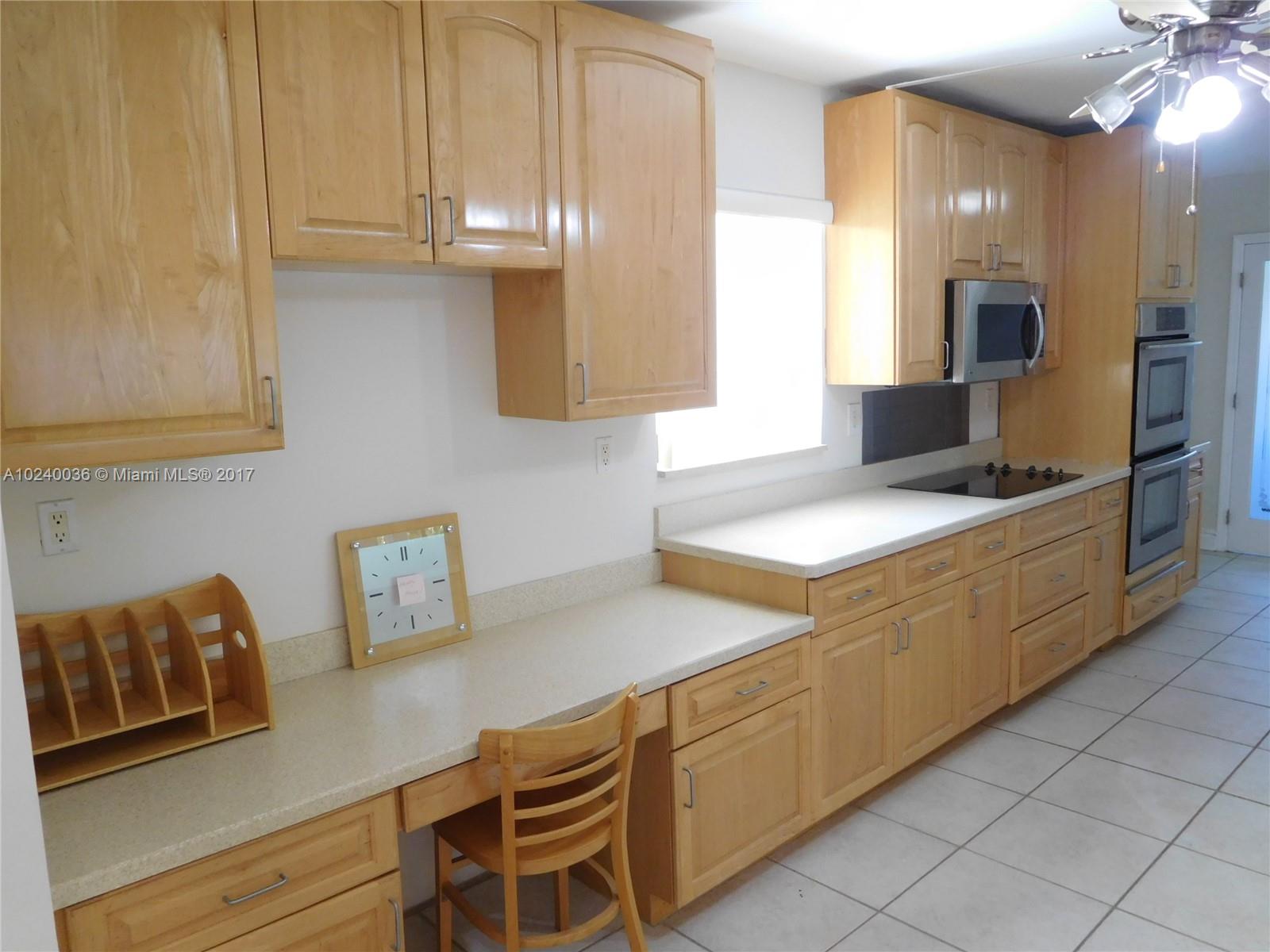 14441 Snapper Drive Coral Gables, FL 33158 - Photo 4 of 27 a kitchen with stainless steel appliances granite countertop a sink and a stove