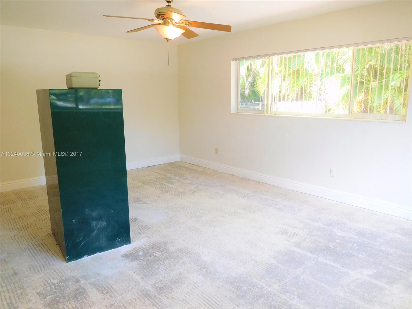 14441 Snapper Drive Coral Gables, FL 33158 - Photo 10 of 27 an empty room with windows and outdoor view