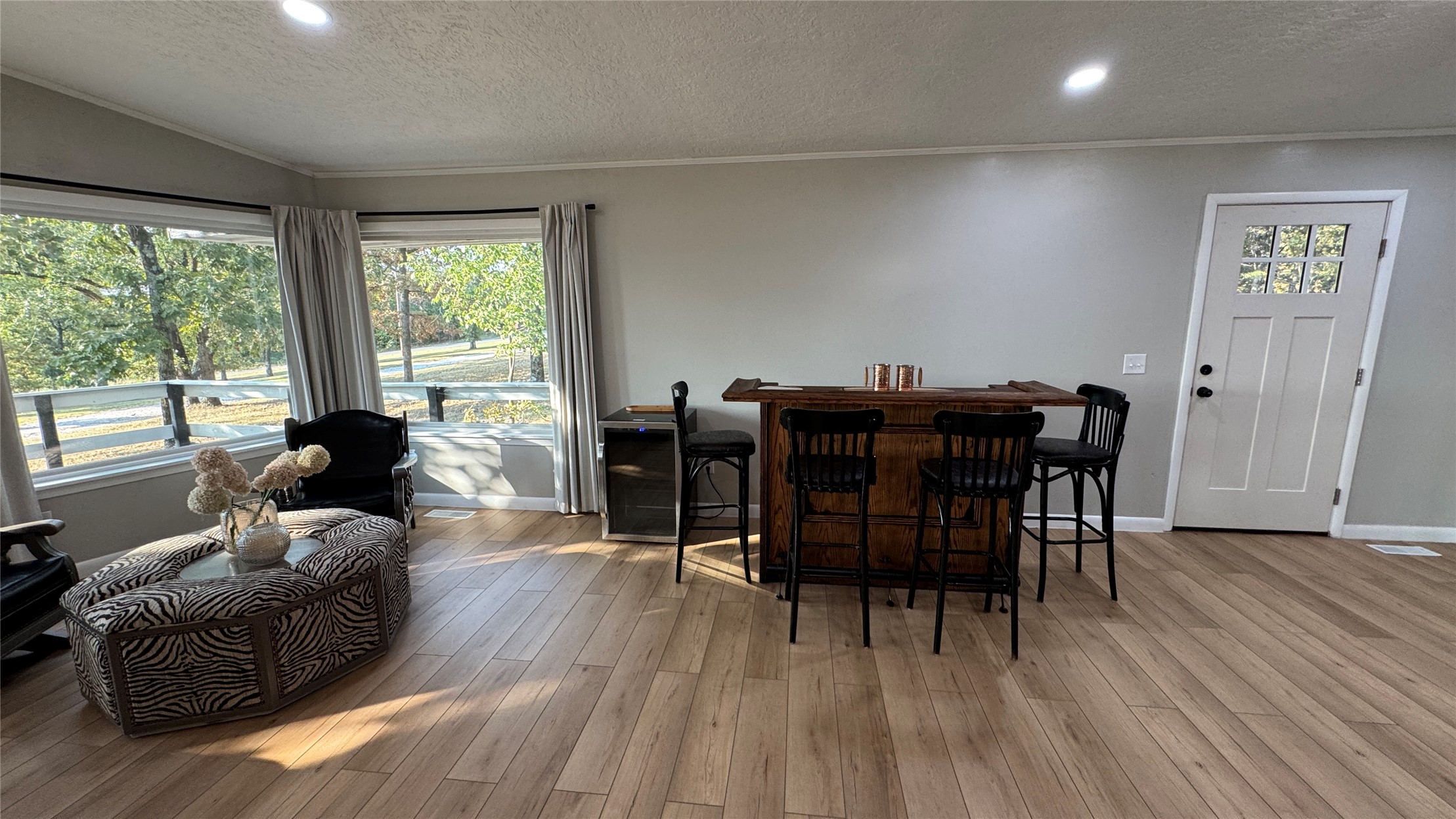 96358 South 4531 Road Vian, OK 74962 - Photo 13 of 58 Hardwood-finish flooring, recessed lighting, expansive windows, a built-in bar, and a paneled entry door
