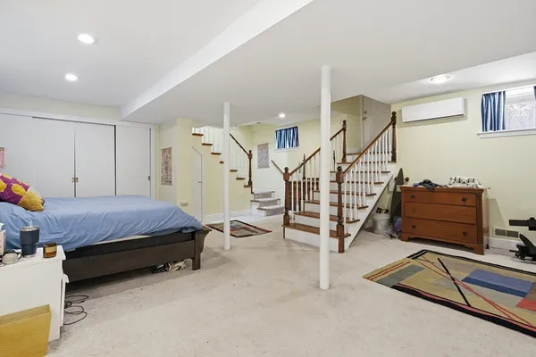 a spacious bedroom with a bed and a cabinets