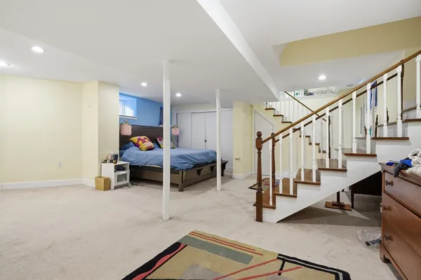 a view of a livingroom with furniture and stairs