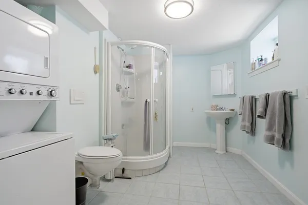 a bathroom with a toilet and a shower
