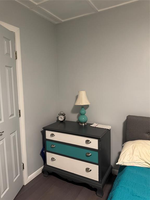 708 West 1st Street Hico, TX 76457 - Photo 12 of 24 a bedroom with a bed and a lamp on dresser
