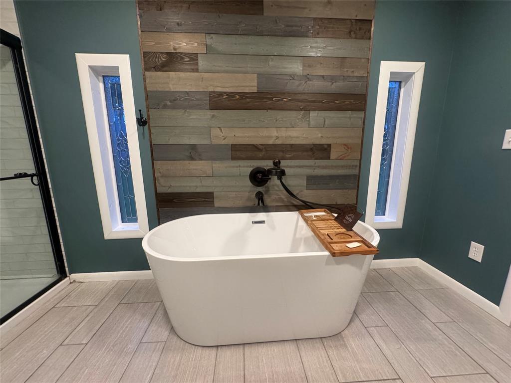 708 West 1st Street Hico, TX 76457 - Photo 16 of 24 a white bath tub sitting in a bathroom
