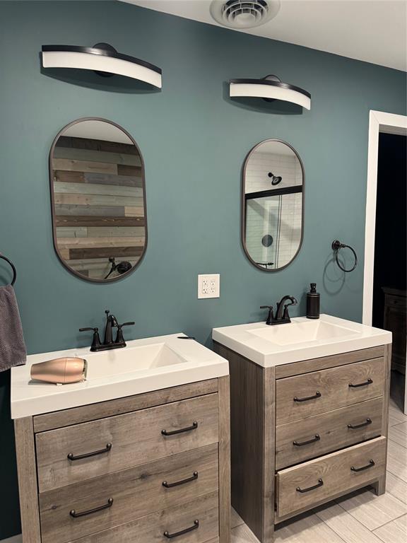 708 West 1st Street Hico, TX 76457 - Photo 18 of 24 a bathroom with a sink a mirror and vanity