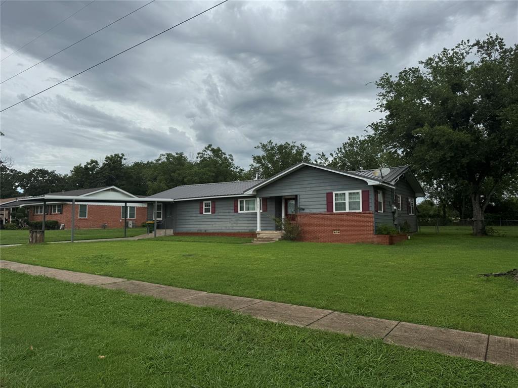 708 West 1st Street Hico, TX 76457 - Photo 2 of 24 a front view of a house with a yard