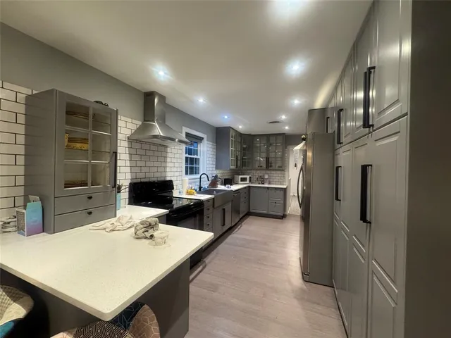 a kitchen with a refrigerator and a sink