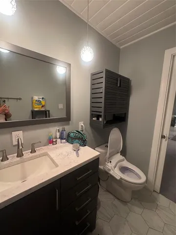 a bathroom with a toilet sink and mirror
