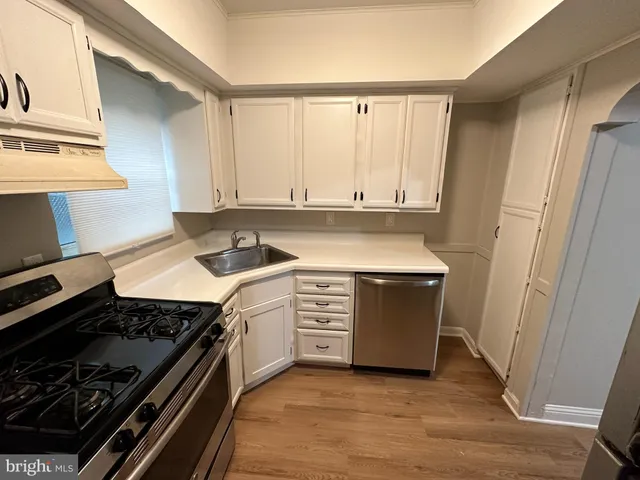 a kitchen with a stove and white cabinets