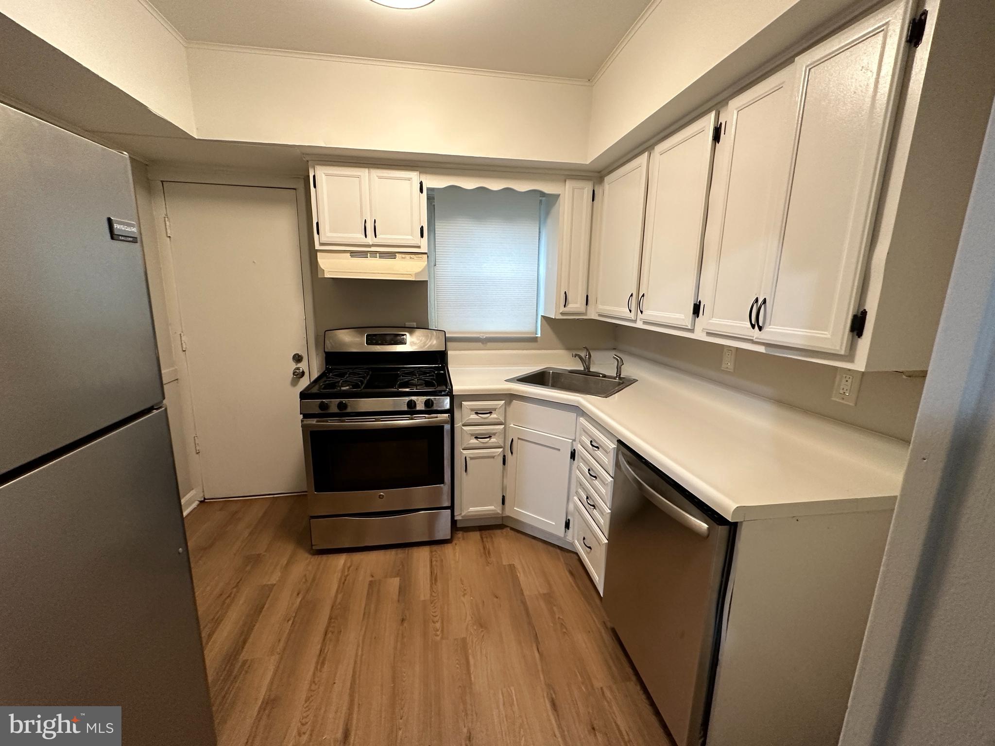 1909 South Hemberger Street Philadelphia, PA 19145 - Photo 4 of 12 a kitchen with a sink a stove and cabinets