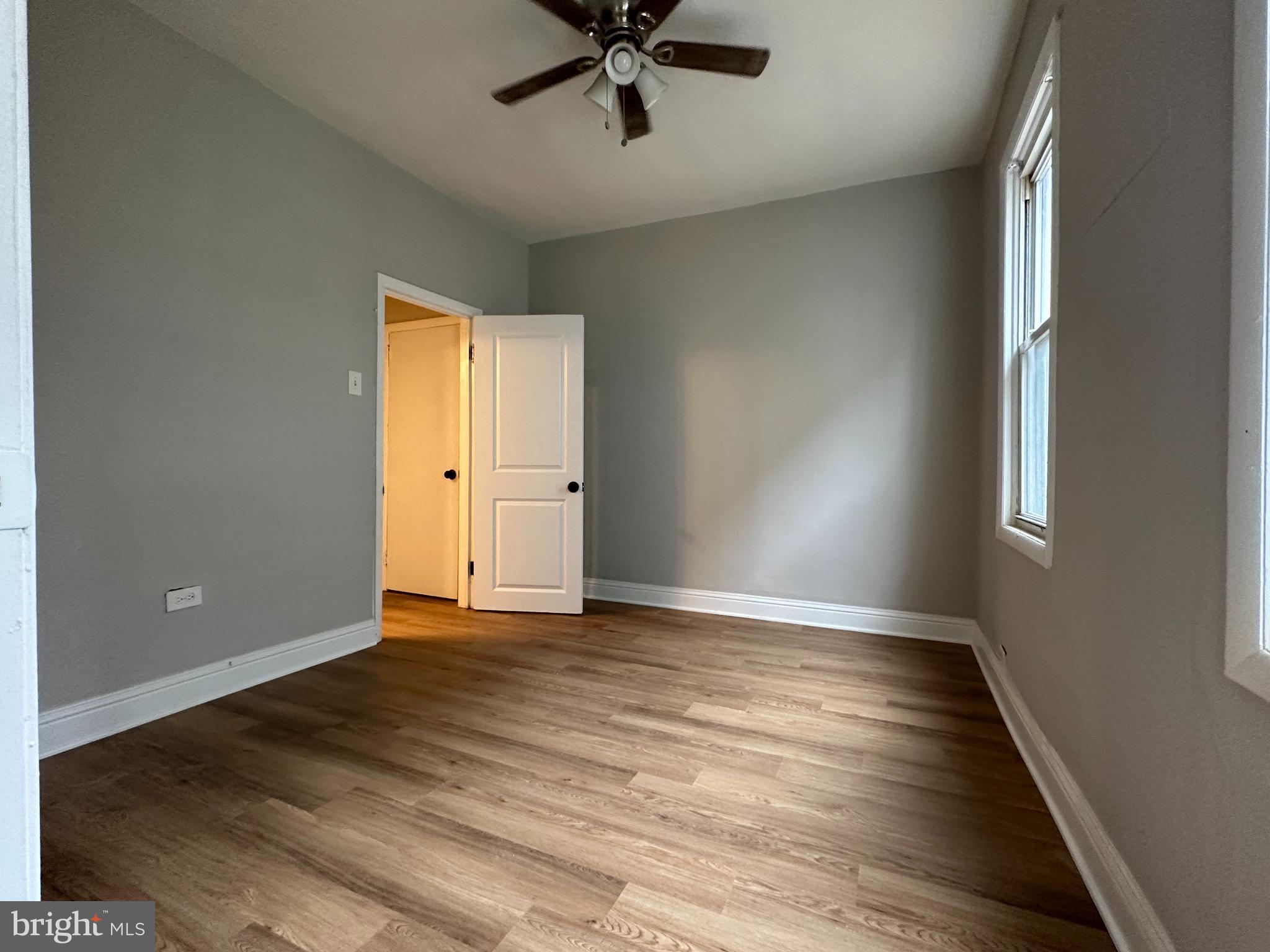 1909 South Hemberger Street Philadelphia, PA 19145 - Photo 8 of 12 wooden floor in an empty room with a window