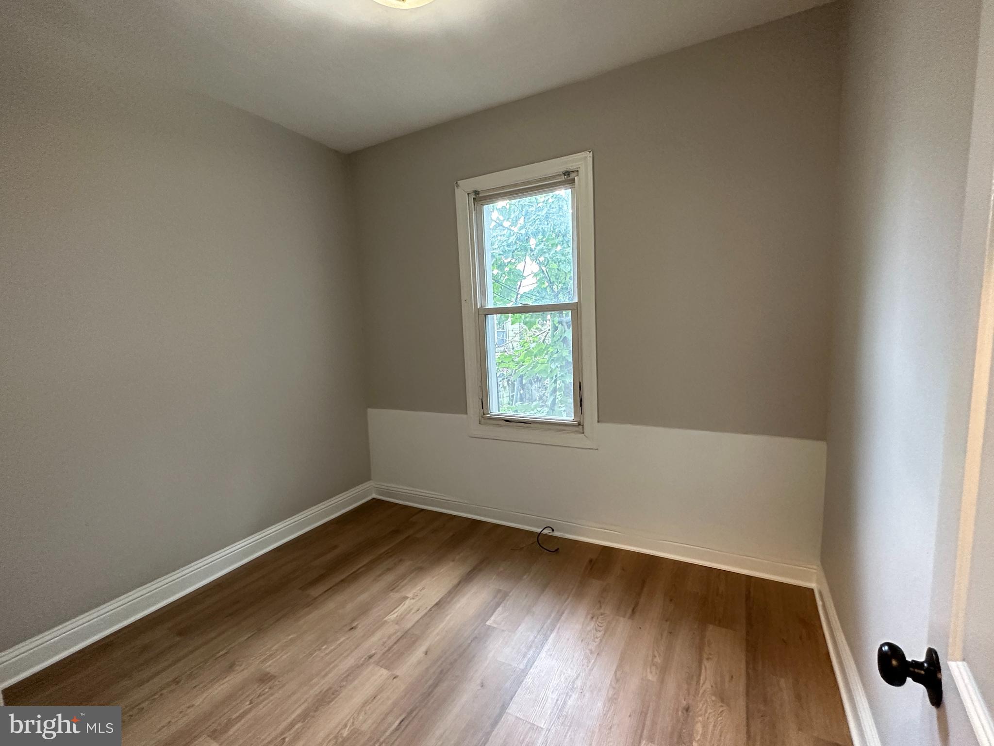 1909 South Hemberger Street Philadelphia, PA 19145 - Photo 9 of 12 an empty room with wooden floor and windows