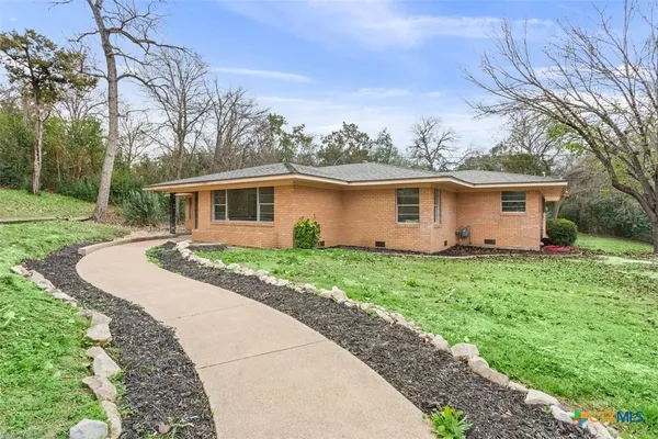a front view of house with yard and green space