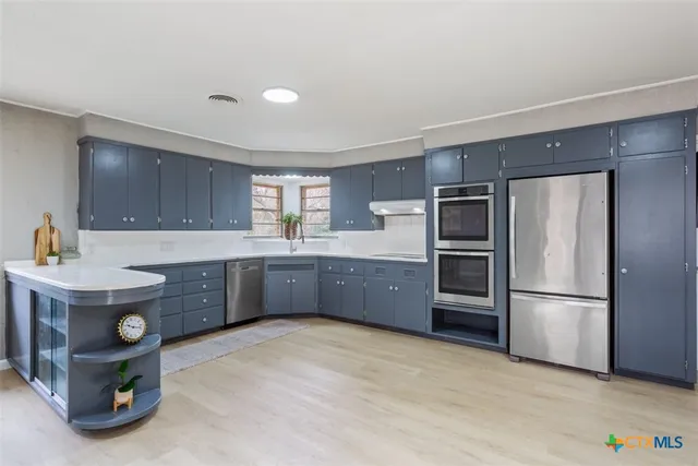 a kitchen with a sink and a refrigerator