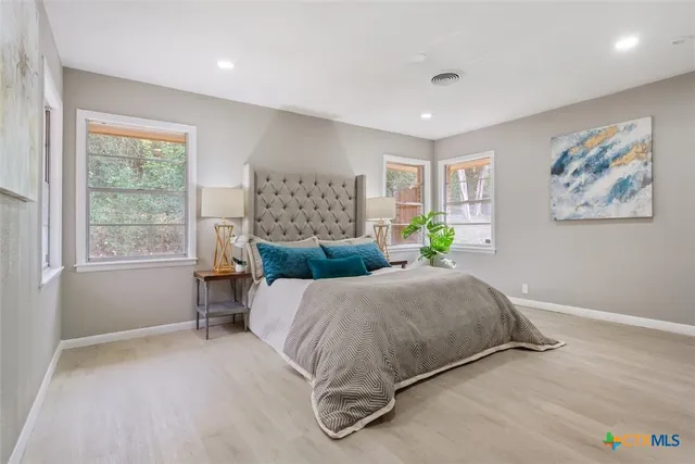 a bedroom with a large bed and window