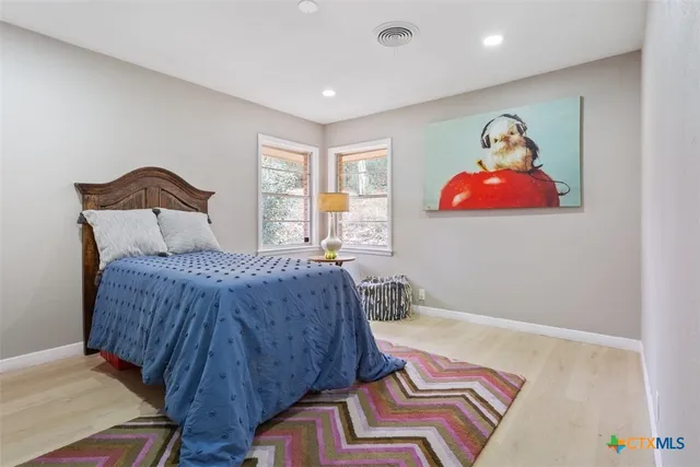 a bedroom with a bed and a lamp