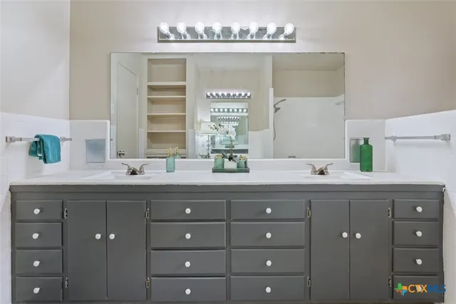 a spacious bathroom with a double vanity sink mirror and