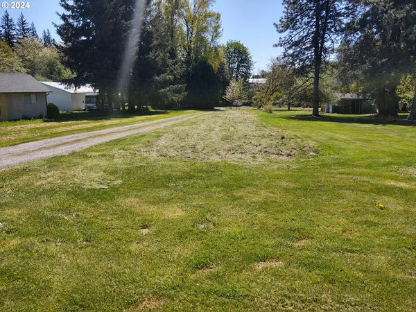 a view of a yard with swimming pool
