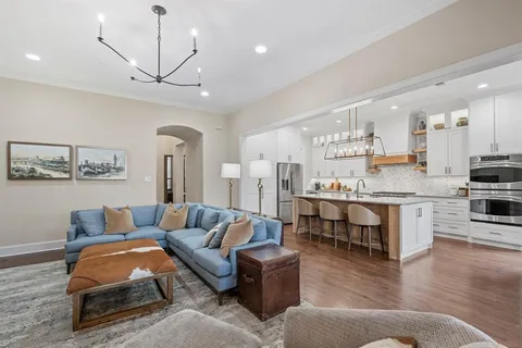a living room with furniture and kitchen view