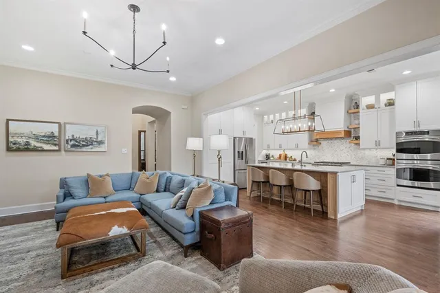 a living room with furniture and kitchen view