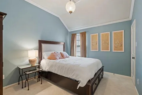 a bedroom with a bed lamp and a window