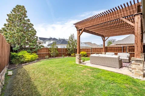 a view of a garden with an outdoor seating