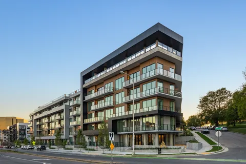 a view of a tall building next to a road