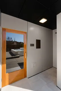a view of a balcony with chairs and a table under an umbrella
