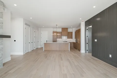 a view of a kitchen with kitchen island stainless steel appliances refrigerator sink and cabinets
