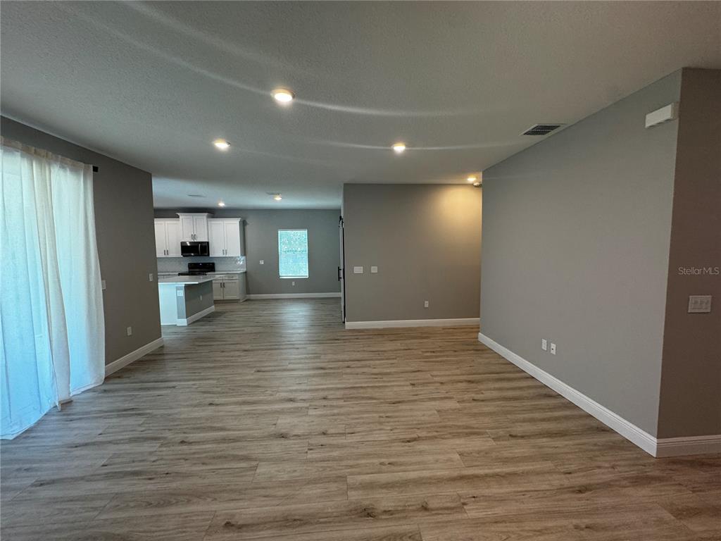 13101 Southwest 72nd Terrace Road Ocala, FL 34473 - Photo 2 of 18 a view of empty room with wooden floor