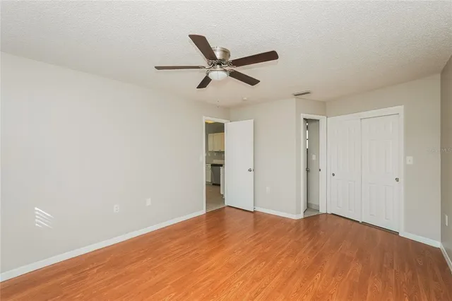 a view of empty room with wooden floor
