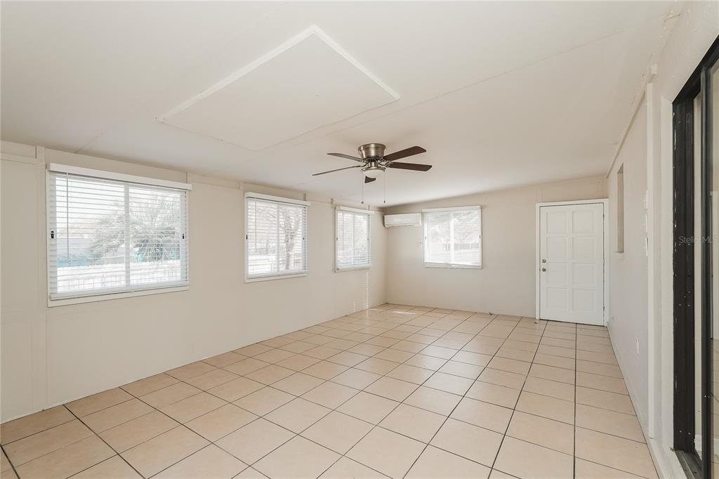12165 Rockford Street Spring Hill, FL 34608 - Photo 8 of 16 a view of an empty room with a window