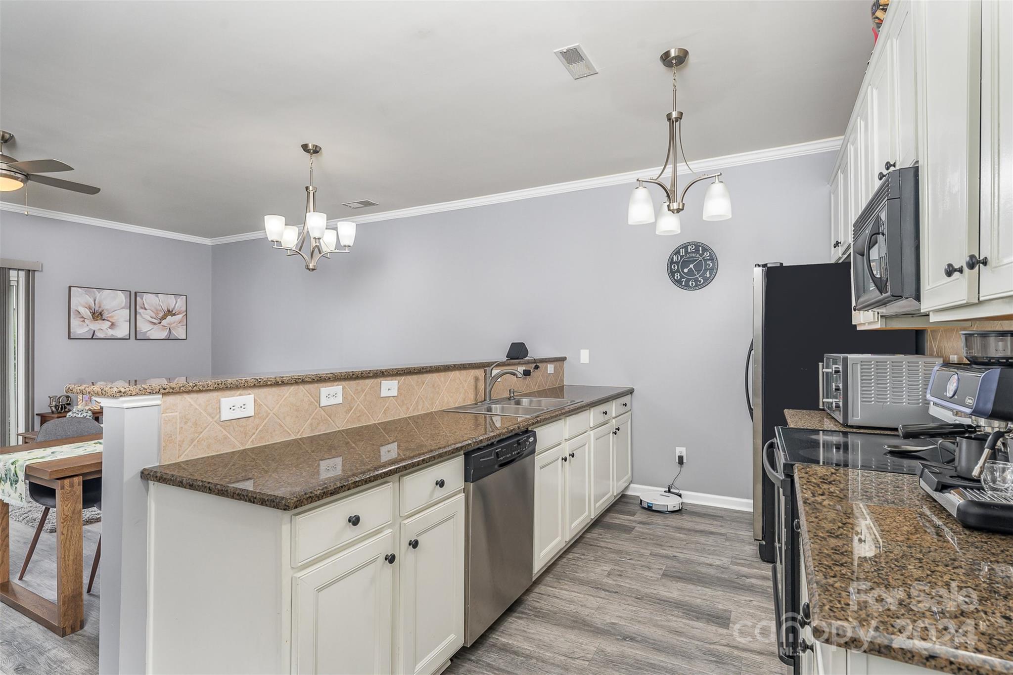1308 Smokey Quartz Lane Fort Mill, SC 29708 - Photo 8 of 24 a kitchen with granite countertop a sink cabinets and stainless steel appliances