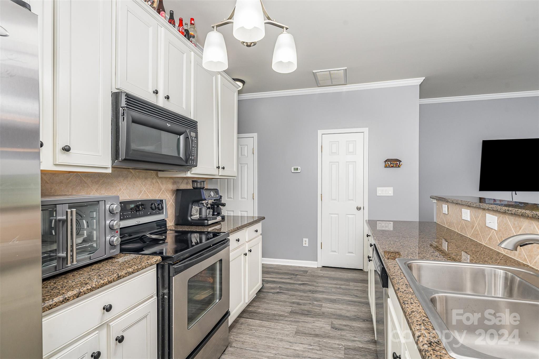1308 Smokey Quartz Lane Fort Mill, SC 29708 - Photo 9 of 24 a kitchen with stainless steel appliances granite countertop a stove a sink and a microwave