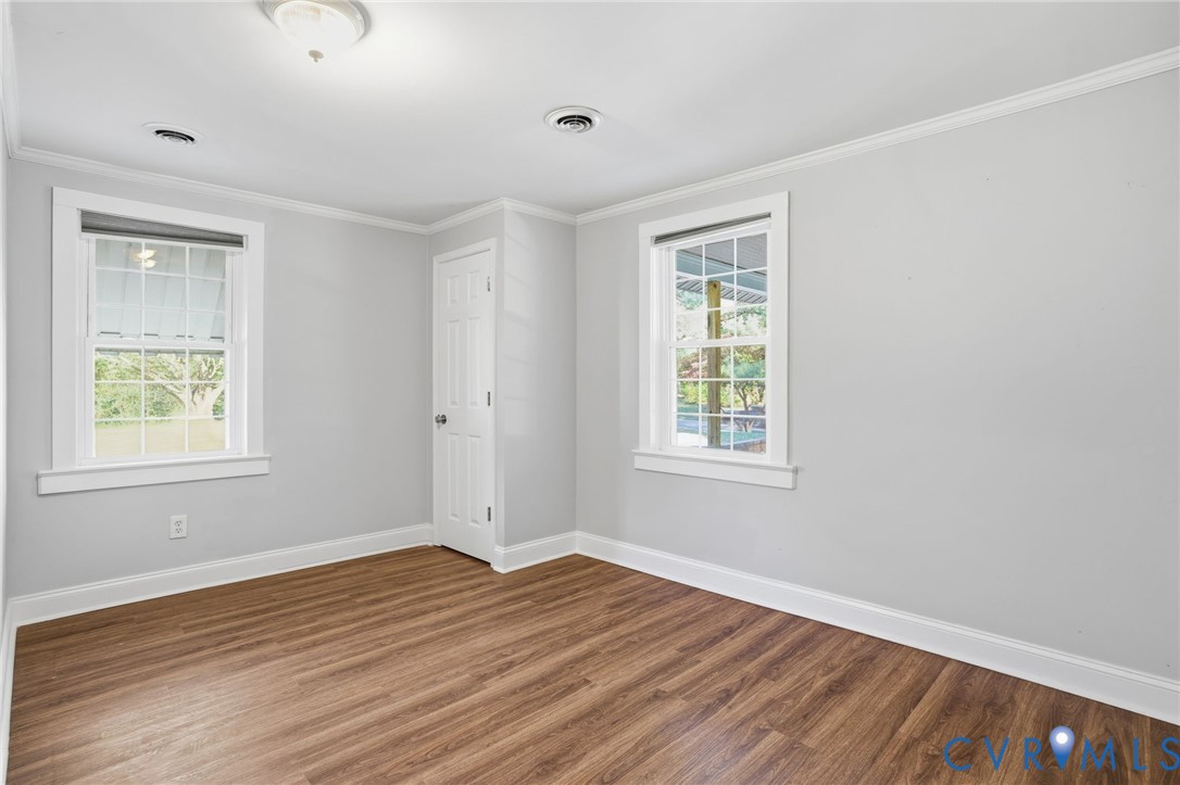 9102 Boydton Plank Road Petersburg, VA 23803 - Photo 16 of 32 a view of an empty room with wooden floor and a window