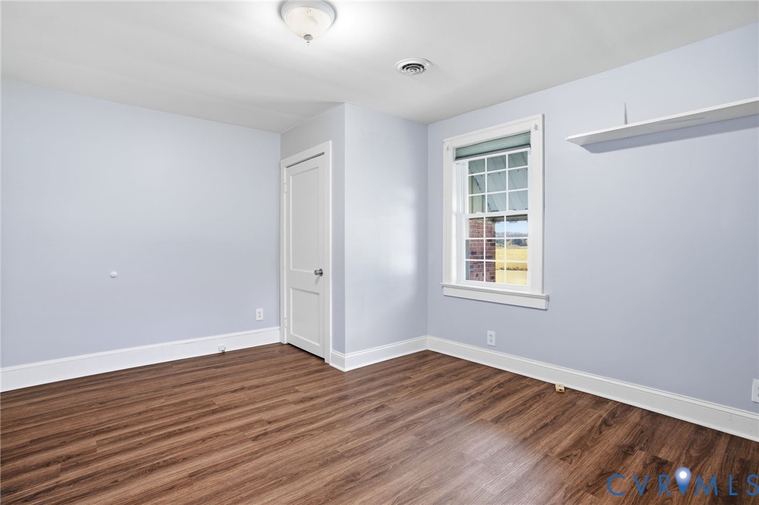 9102 Boydton Plank Road Petersburg, VA 23803 - Photo 21 of 32 a view of an empty room with wooden floor and a window