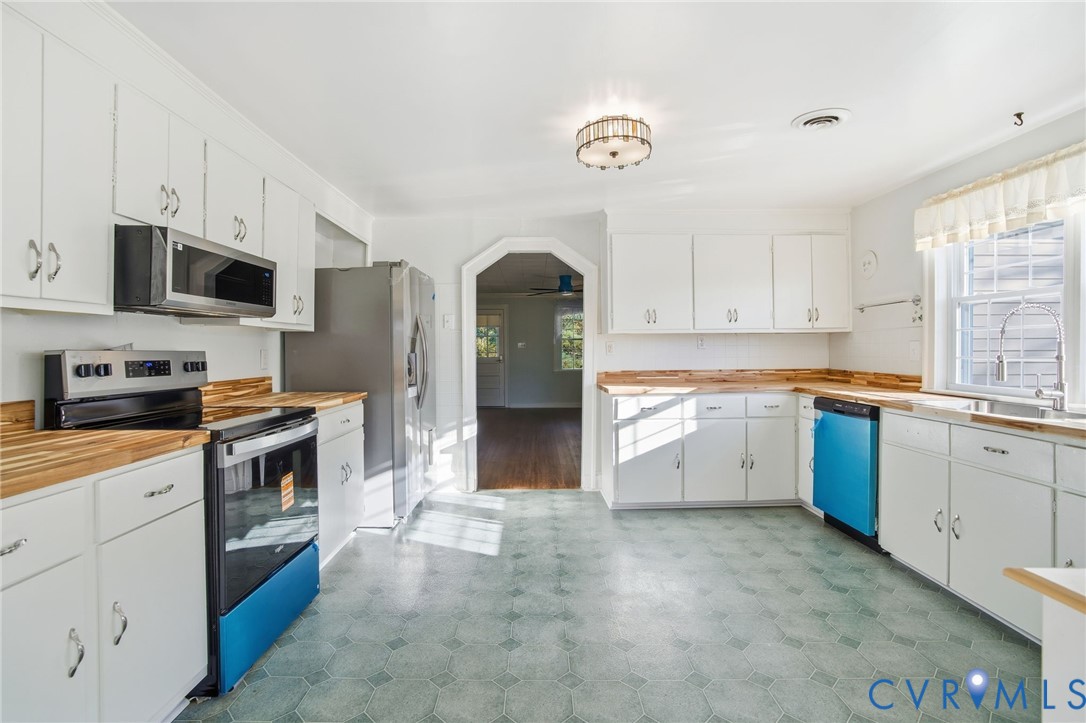 9102 Boydton Plank Road Petersburg, VA 23803 - Photo 4 of 32 a kitchen with granite countertop a stove top oven sink and cabinets