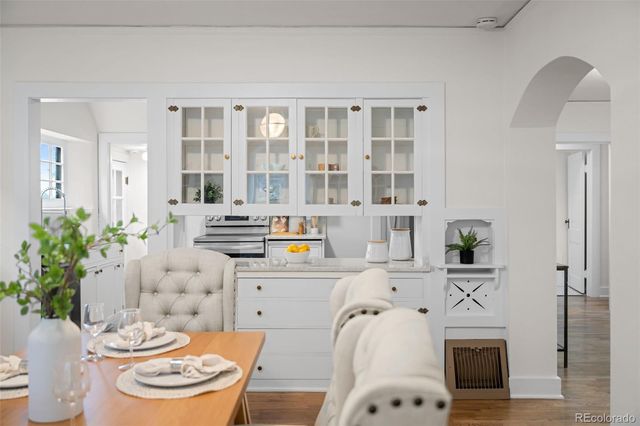 a kitchen with a sink stove and a dining table
