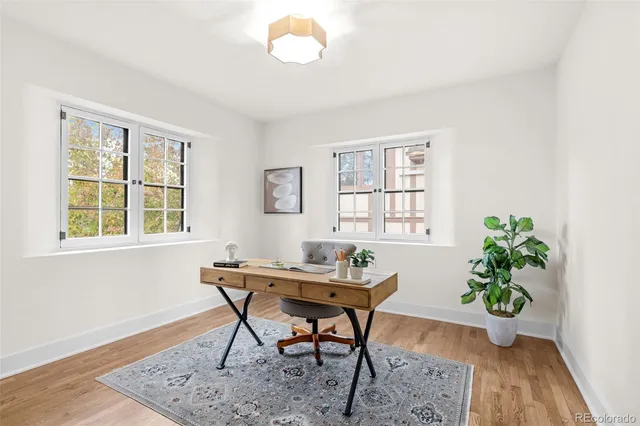 a workspace room with furniture and wooden floor
