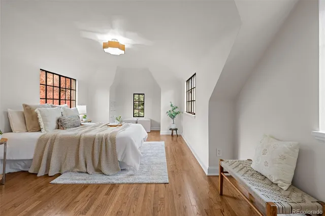 a bedroom with a bed and wooden floor