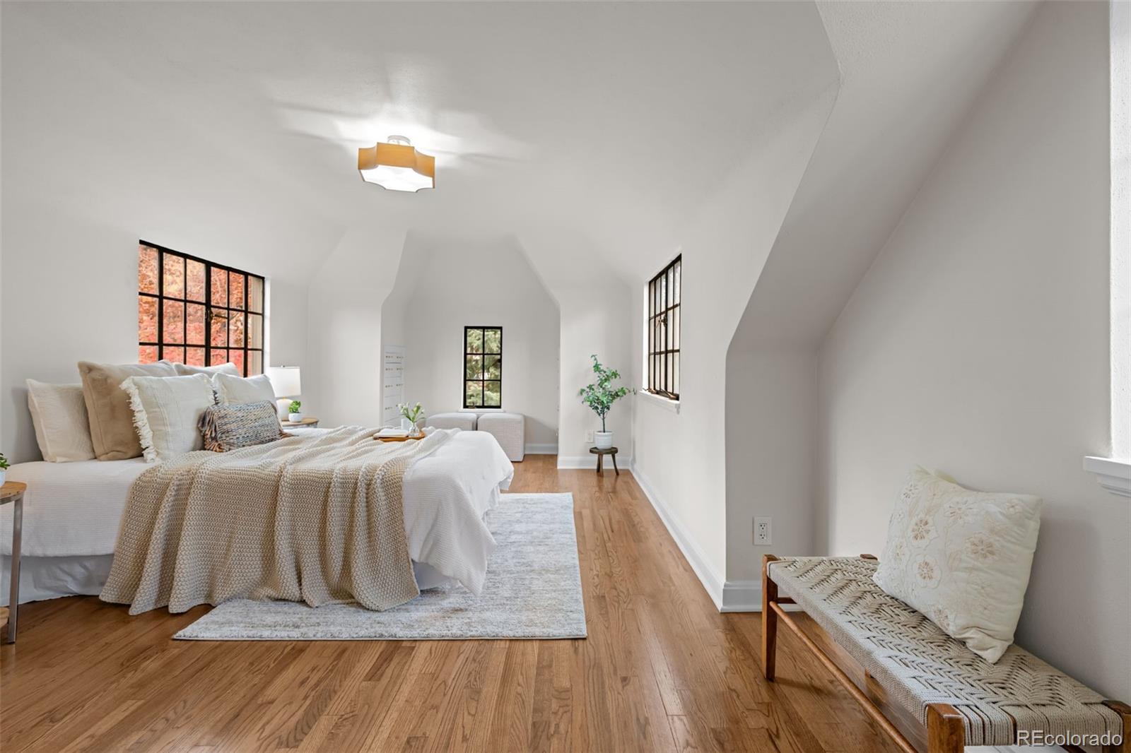 772 16th Street Boulder, CO 80302 - Photo 17 of 26 a bedroom with a bed and wooden floor
