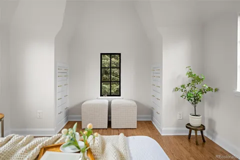 a living room with a bed furniture and a potted plant