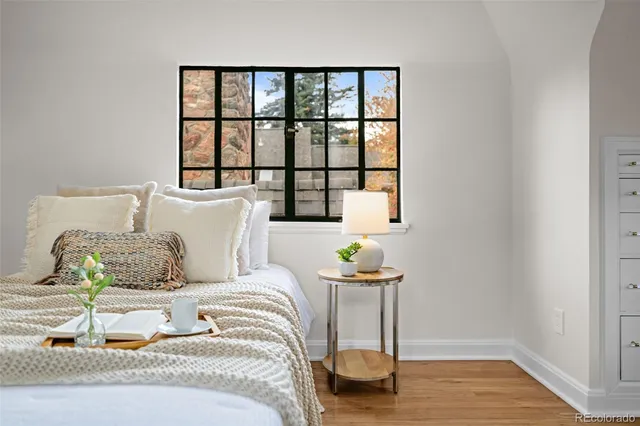 a bedroom with a bed and a window