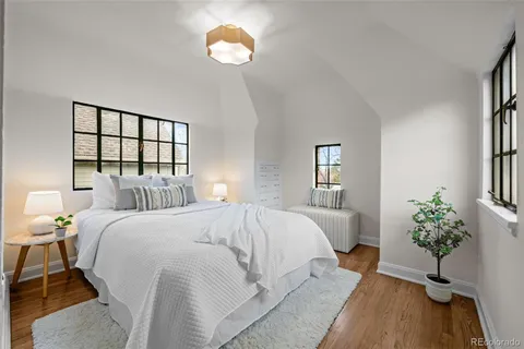 a bed room with a bed and a potted plant